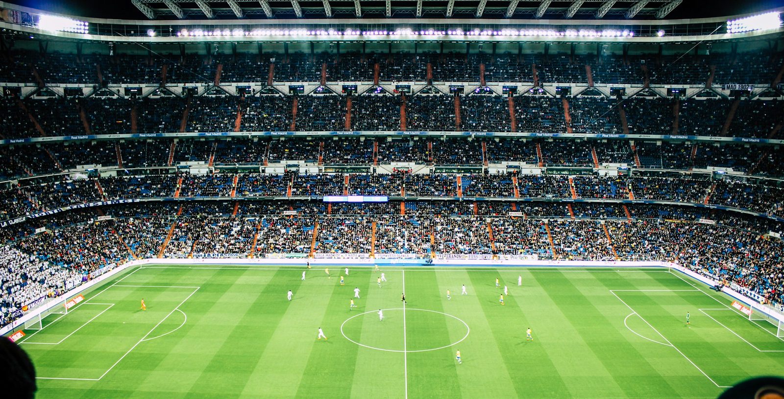 A packed football stadium under floodlights, streamed live on IPPlayTV
